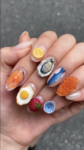 Image of food-themed nail art, egg, oyster, salmon, lemon, strawberry designs, shown during Krea demo