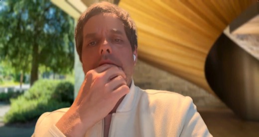 Tony Jones webcam, outdoors, hand covering mouth/chin