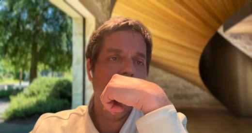 Tony Jones webcam, outdoors, fist resting on chin