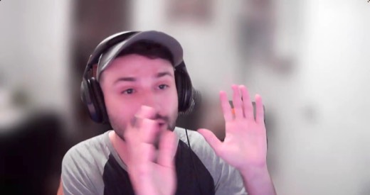Sebastian Sagastume webcam, close-up, hand near mouth, talking