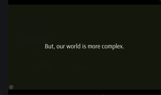A dark slide with the line "But, our world is more complex" displayed in white text on a black background.