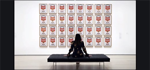 Slide of Andy Warhol's Campbell's Soup Cans installation with a museum visitor seated in front, extending the borrowing/appropriation-art lineage...